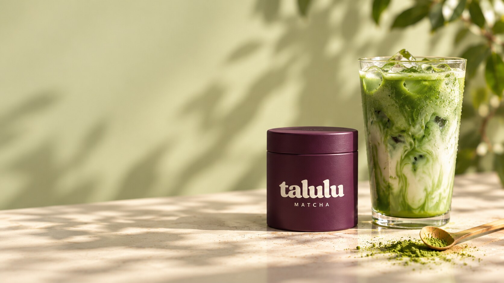 Talulu Matcha tin beside an iced matcha latte in afternoon sun